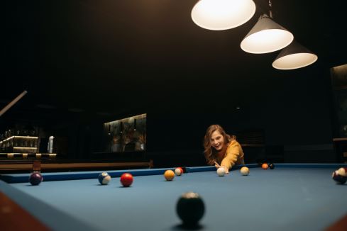a person shooting pool